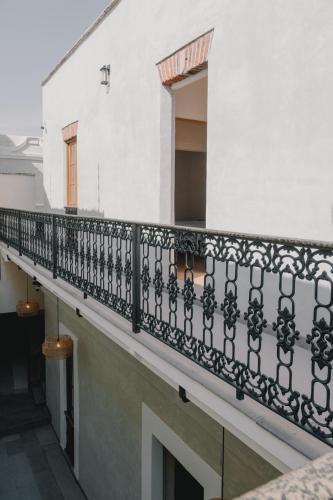 a balcony of a building with a black railing at Hotel Boutique Casa Yága in Querétaro