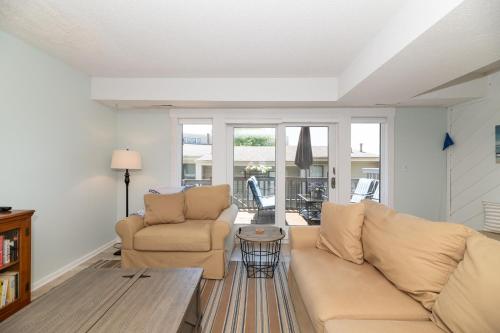 a living room with a couch and a table at Harbours 10- Condo with community pool in South Haven
