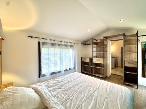 a bedroom with a large bed and a window at Le Pigeonnier d'antan à Beaucaire,Fourques in Beaucaire