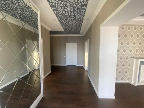 an empty room with a coffered ceiling and a hallway at Villa Mayak in Baku