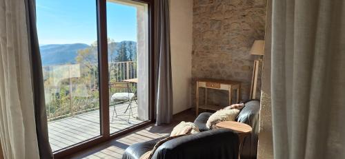 a living room with a couch and a large window at Agriturismo La Pina in Tarzo