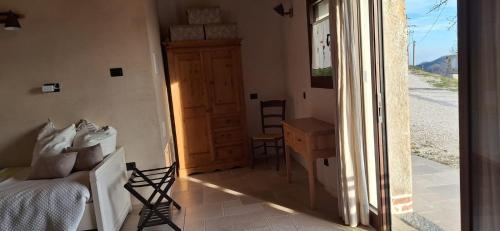a bedroom with a bed and a sliding glass door at Agriturismo La Pina in Tarzo