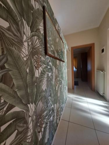 a hallway with a tropical mural on the wall at La Casa Di Fiore in Spoltore