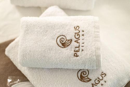 a close up of a towel with the writing on it at Pelagus Luxury Villas in Polykhrono