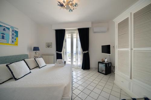 a bedroom with a bed and a television in it at Relais Bijoux Ischia in Ischia