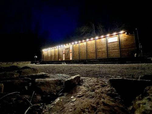 a train car with lights on it at night at Obytný vagón in Kamberk