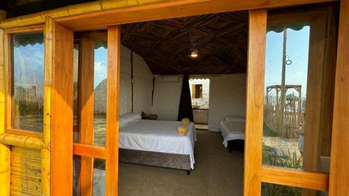 a bedroom with a bed in a room with windows at Guajira Beach in Ríohacha