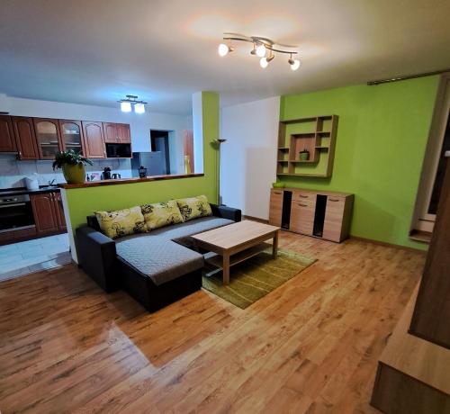 a living room with a couch and a table at Vilarose Apartment in Mohelnice