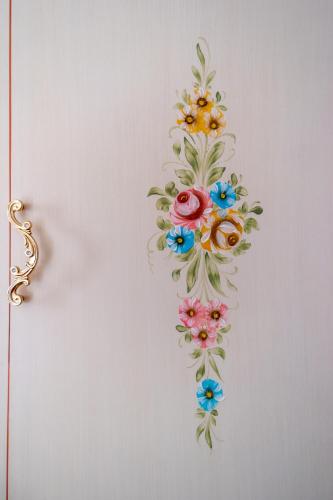 a flower design on a wall with a gold object at Hotel New Aurora Venice in Marghera