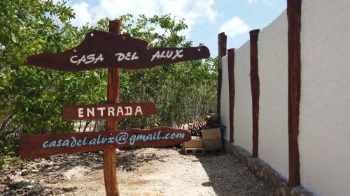 a street sign in front of a building at La Casa del Alux - Adults Only in Holbox Island