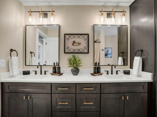 a bathroom with two sinks and two mirrors at 4BD Home - Games - Close to Downtown & Snowbowl in Flagstaff