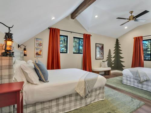 a bedroom with a large bed and red curtains at 4BD Home - Games - Close to Downtown & Snowbowl in Flagstaff