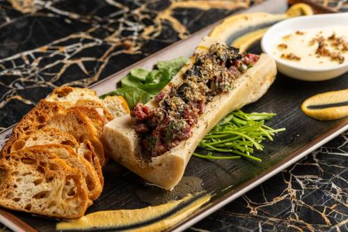 a sandwich on a plate with bread and vegetables at InterContinental - Los Angeles Downtown by IHG in Los Angeles