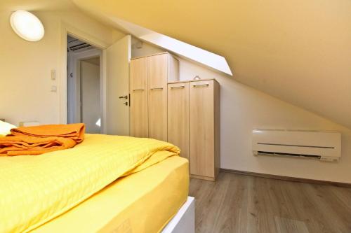 a bedroom with a bed with an orange blanket at Apartment Ivo P. in Šilo