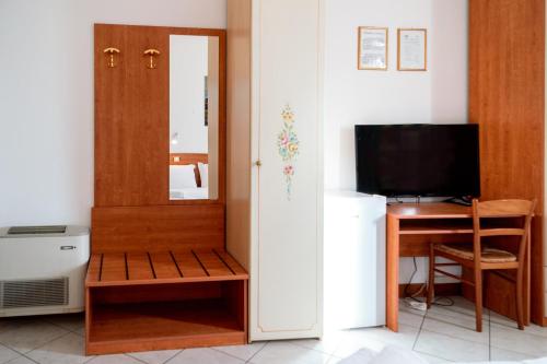 a room with a door and a desk and a television at Hotel New Aurora Venice in Marghera