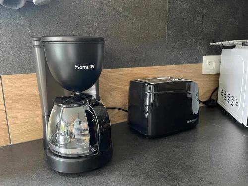 a blender and a toaster sitting on a counter at Charming Chalet in Roisin, 400 m² with Terrace in Meaurain