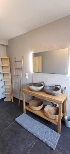 two sinks on a shelf in a room with a wall at Charming Chalet in Roisin, 400 m² with Terrace in Meaurain