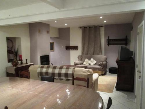 a living room with a couch and a table at Spacious house in Montignies-sur-Roc with garden in Montignies-sur-Roc