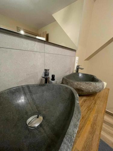 a bathroom with a large tub and a sink at Charming Chalet in Roisin, 400 m² with Terrace in Meaurain