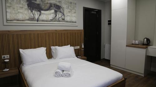 a bedroom with a bed with two towels on it at Golden Sun Kobuleti in K'obulet'i