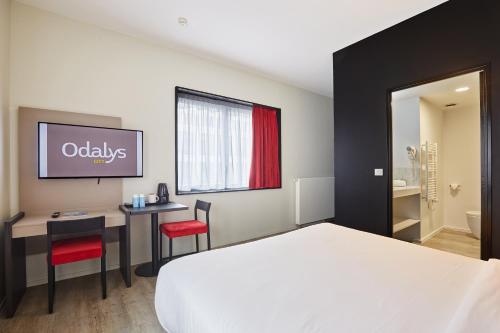 Ένα ή περισσότερα κρεβάτια σε δωμάτιο στο Appart Hotel Odalys City Paris XVII