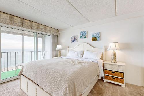 a bedroom with a bed and a large window at English Towers 804 in Ocean City