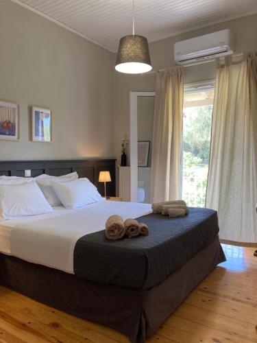 a bedroom with a large bed with towels on it at Yia Sou Corfu! "Kolibri" in Sinarádes