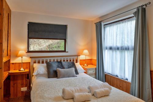 a bedroom with a bed with two towels on it at Finest Retreats - Wolf Rock in Sennen