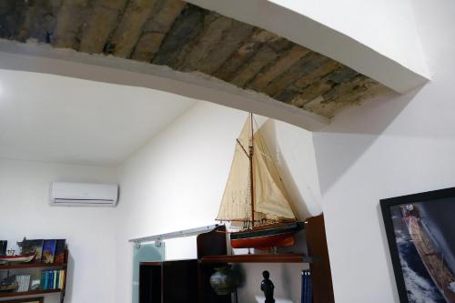 a room with a wooden ceiling with a boat on it at Tosti 79 in Formia