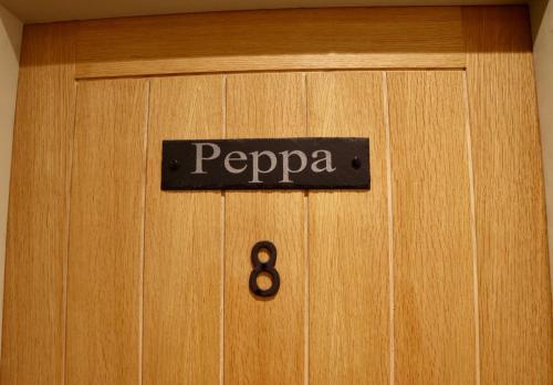 a wooden door with a sign that says papapa on it at The Pig Inn in Snaith