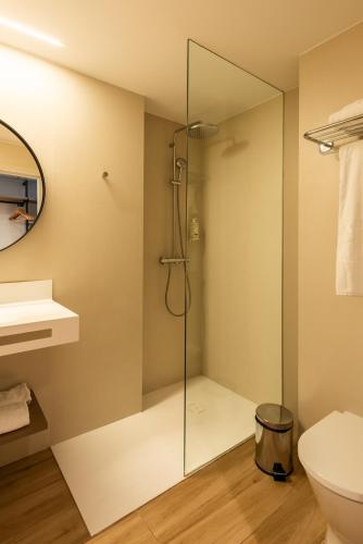 a bathroom with a shower with a glass door at Silken Puerta de Irati in Ochagavía