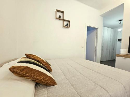 a bedroom with a bed with pillows on it at MONZA-MILANO - Comfort tra centro e stazione - WIFI in Monza