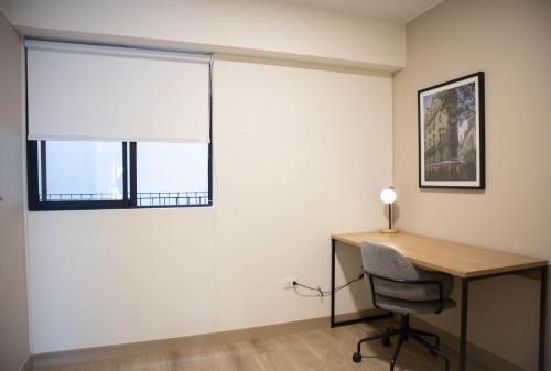 an office with a desk and a window with a window shade at Pod by Wynwood House in Lima