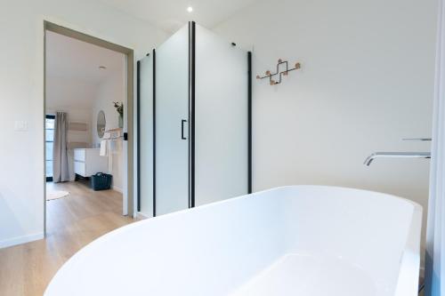 a room with white cabinets and a mirror at Nature'Hayette in Tenneville