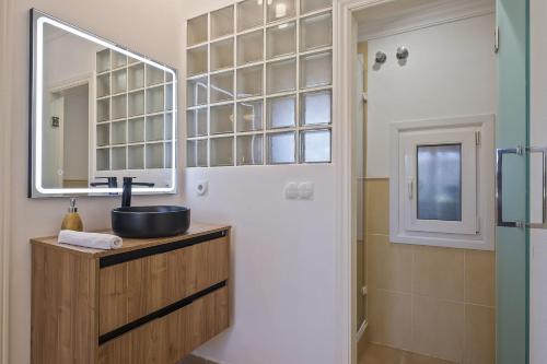 a bathroom with a sink and a mirror and a shower at Cala Serena by Midelisa in Oliva