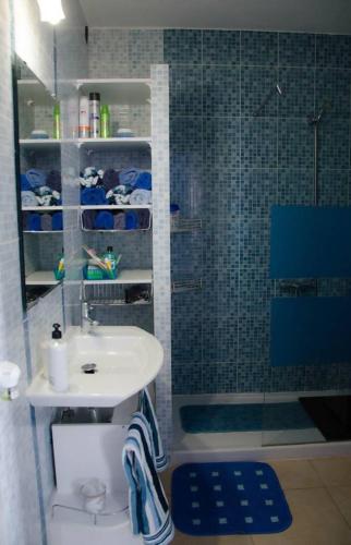 a bathroom with a sink and a shower with a toilet at "Mi casita de la playa" in Arrieta