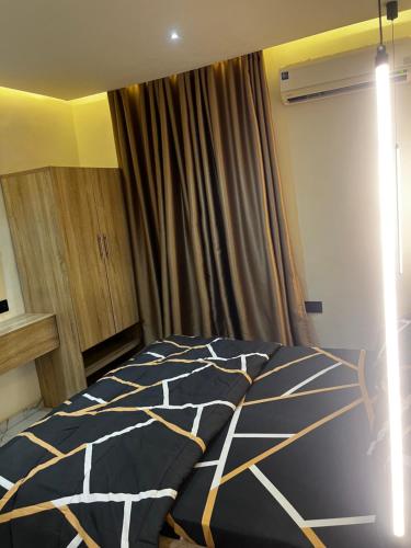 a bedroom with a bed with a black and white comforter at BISTRUCTHOMEs in Meran