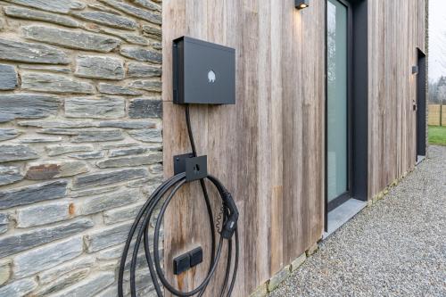 a wall with an appleplug attached to a building at Nature'Hayette in Tenneville