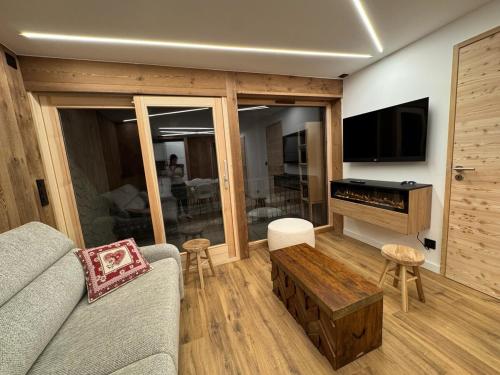 a living room with a couch and a flat screen tv at T3 sur les pistes - Les Claux in Vars