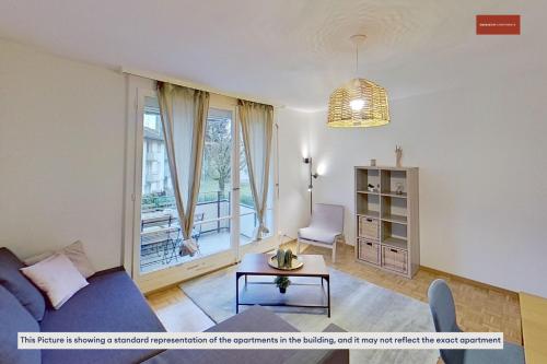 a living room with a blue couch and a table at Charming Apartment 15 Mins from City Life in Zürich