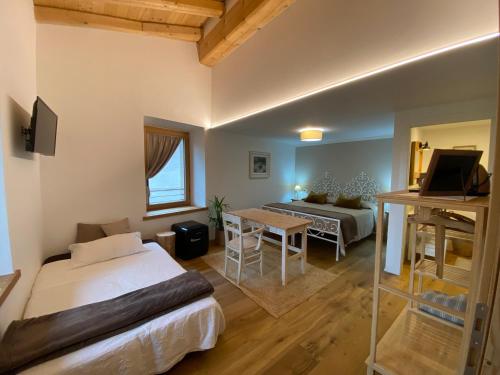 a bedroom with a bed and a table and a couch at Pedegagia in Vezzano