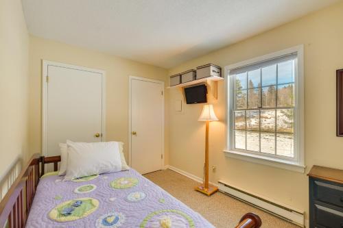 a bedroom with a bed and a window at Homey Windham Condo Hike and Ski the Catskill Mtns! in Windham