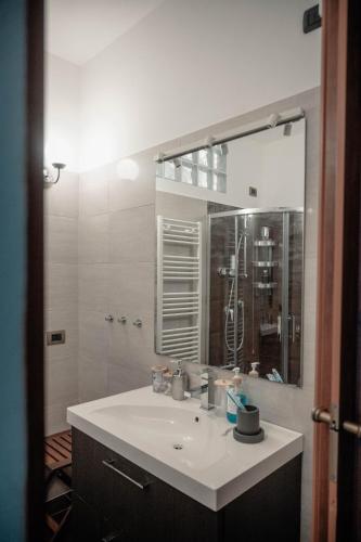 a bathroom with a sink and a large mirror at Casa Giulietta Junior20 with private parking in Blevio