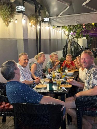 a group of people sitting at a table in a restaurant at Violet in An Bang
