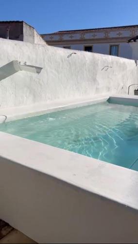 a plunge pool with blue water in front of a building at Casa Garcia in Amareleja