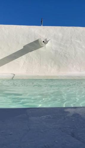 a paper airplane is flying over the water at Casa Garcia in Amareleja