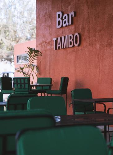 a group of tables and chairs in front of a bar tambo at Azalaï Hôtel Ouagadougou in Ouagadougou