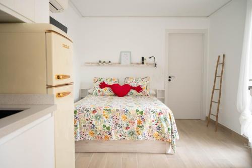 a bedroom with a bed with a red heart pillow at Habitaciones independientes con baño - Villas Costa del Sol in Benajarafe