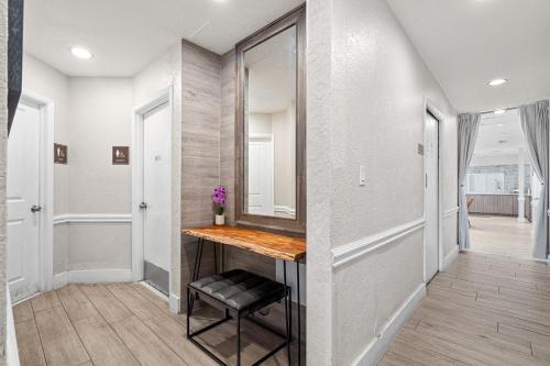 a hallway with a table and a mirror at Hotolos Hollywood in Hollywood