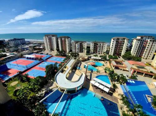 an aerial view of a resort with several pools at Playa Almendro Resort - Tonsupa in Tonsupa